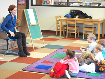 A woman reading to children