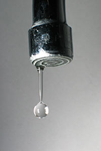 A water drop leaks from a faucet