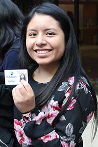 A JTOP employee proudly displays her City of Hillsboro badge