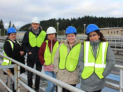 JTOP employees pose in hard hats at the water treatment plant