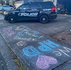 We Love HPD and the names of K-9s Jessie, Blazer, Rockett and Ace are drawn on a neighborhood sidewalk