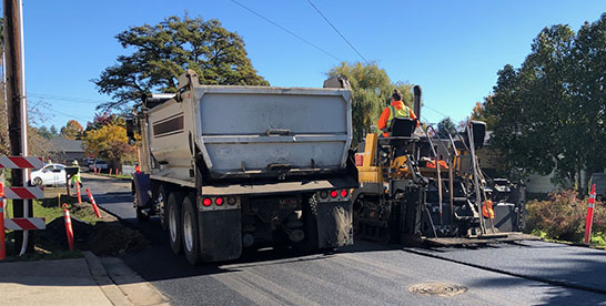 Workers repaving a roadway.