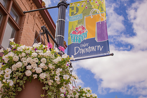 Downtown Hillsboro hanging basket with downtown flag banner