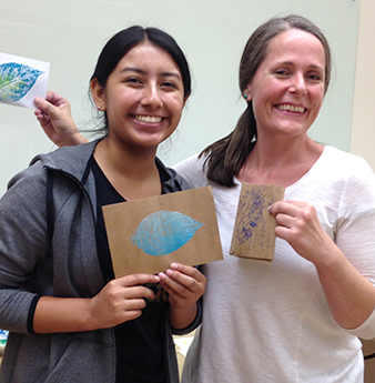 Volunteers Ellie Villaraldo and Alisa McDonald helping with an art actibity