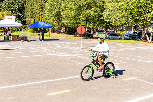 Child riding bike on Traffic Playground in Evergreen Park during 2021 Celebrate Hillsboro event.