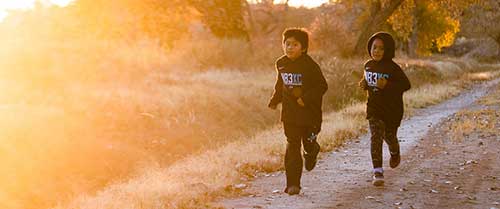 Children run wearing sportswear from Nike's N7 collection