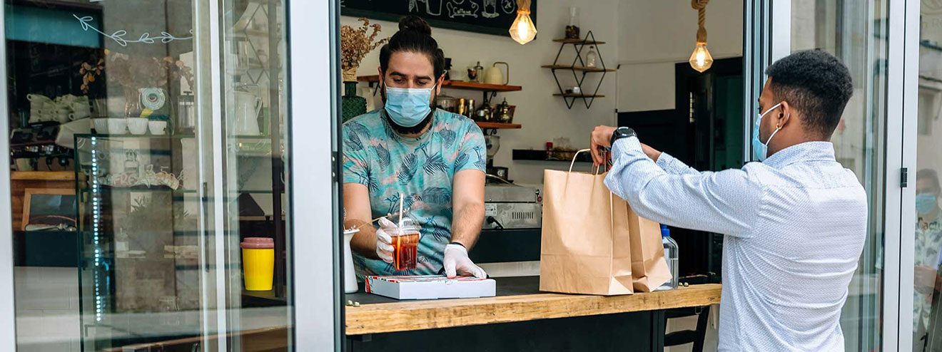 A person picks up takeout from a small business