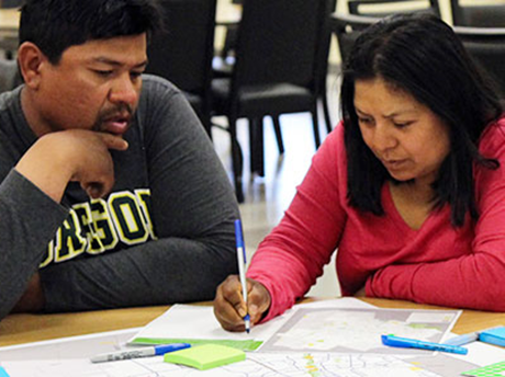 Two people take notes at a focus group meeting