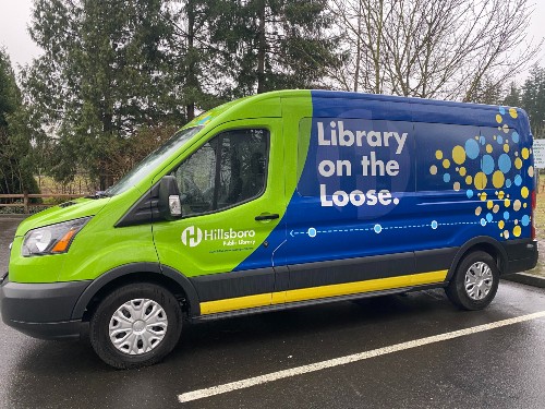 Green and blue Library on the Loose Van