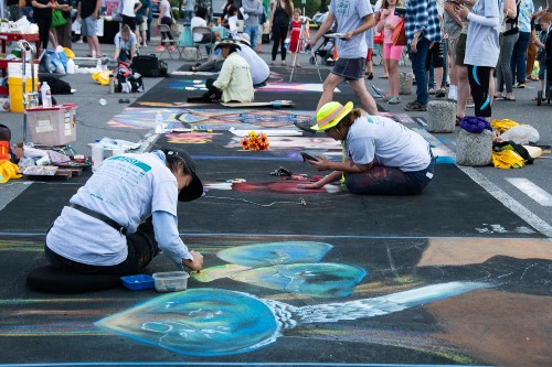 Artists in action working on chalk art pieces at La Strada 2019