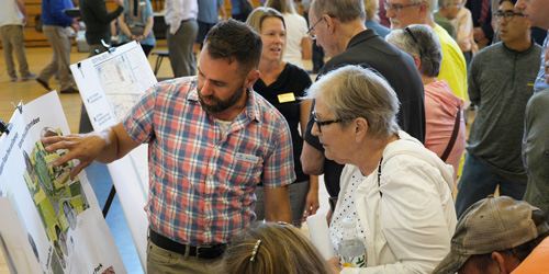 Ryan Stee points community members to a map at an informational meeting