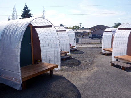 Multiple Safe Rest Pods (Conestoga Huts) at a shelter site