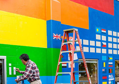 Arturo Villasenor painting a mural at the Boys and Girls Club