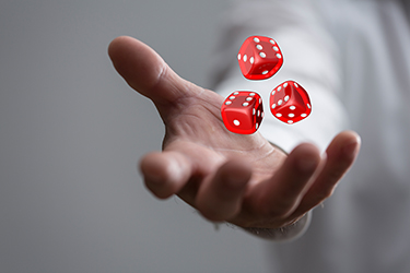 A person tossing three dice.