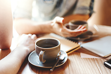 Two people drinking coffee.