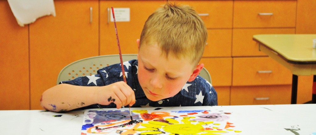 Young boy in the process of painting