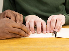 Person using braille to read