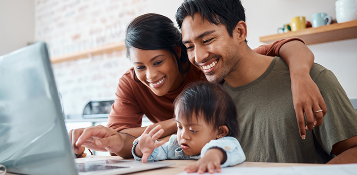 Family gathered around laptop