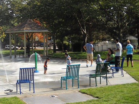 Children and families cool off at the Walnut Street splashpad