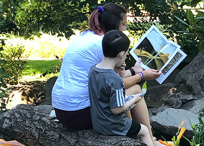 Woman and child reading in park