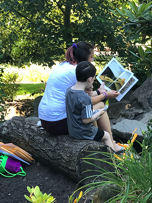 Woman and child reading in park