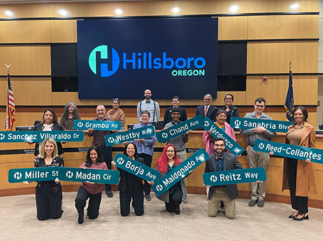 Graduates of the 2023 Civic Leadership Academy post with Hillsboro street signs that bear their last names