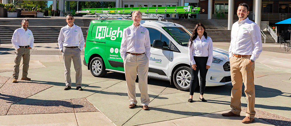 HiLight team members standing by HiLight vehicle