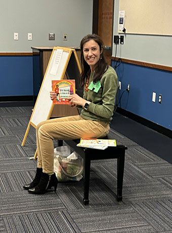 Bushra Ayoub showcases a book at Arabic Storytime