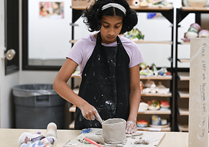 Teen working on a clay creation