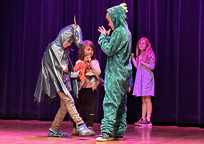 Youth students performing in a theatre class