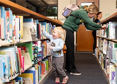 Little girl selecting a book