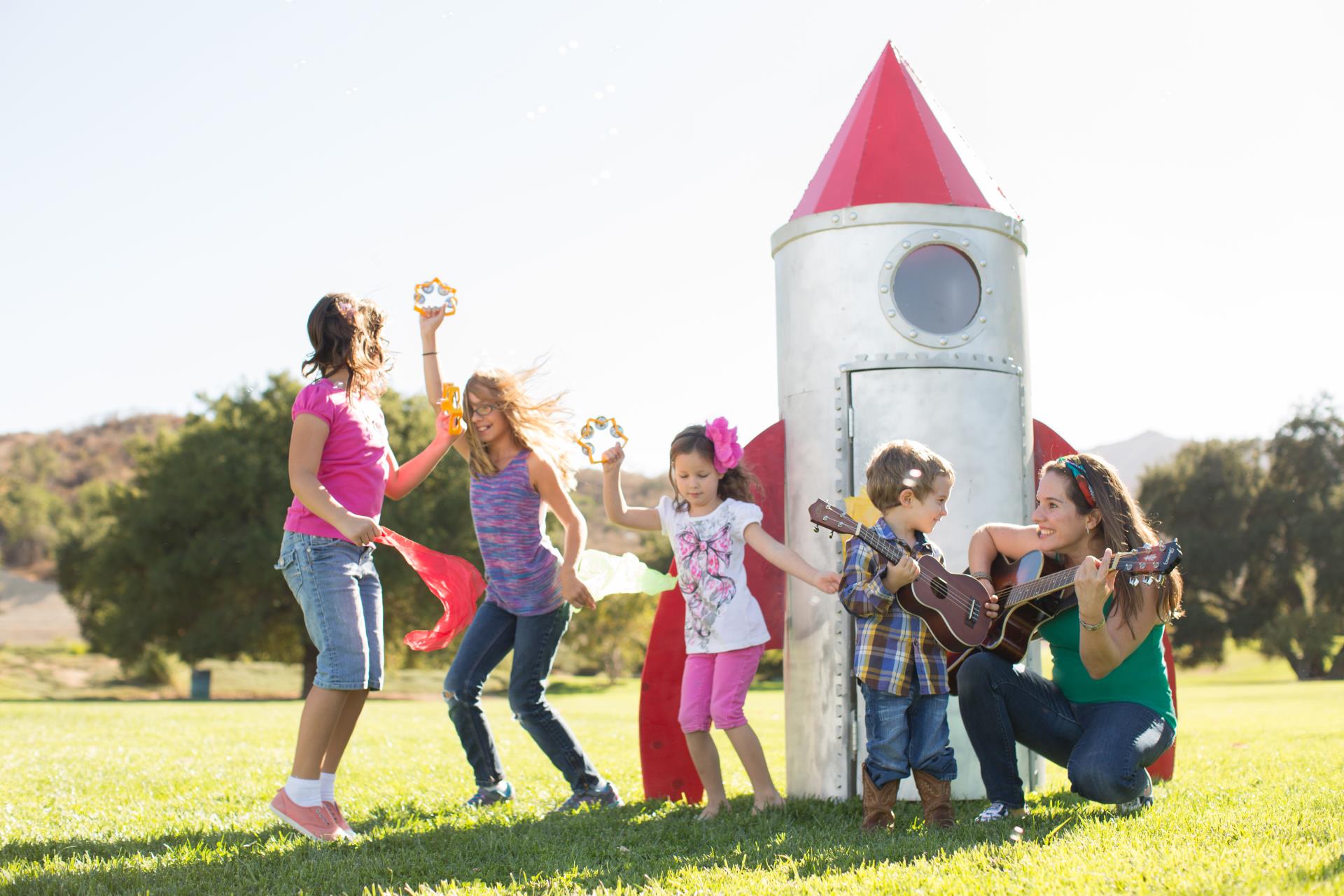 Nathalia with children around a play rocket