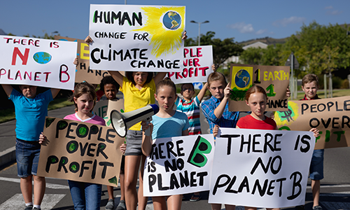 Children hold up signs with anti-climate change slogans