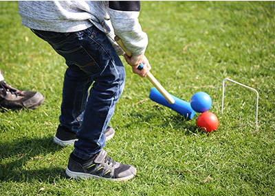 Kid playing croquet