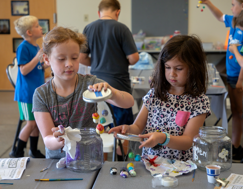 2 kids working on a project at a Jackson Bottom program