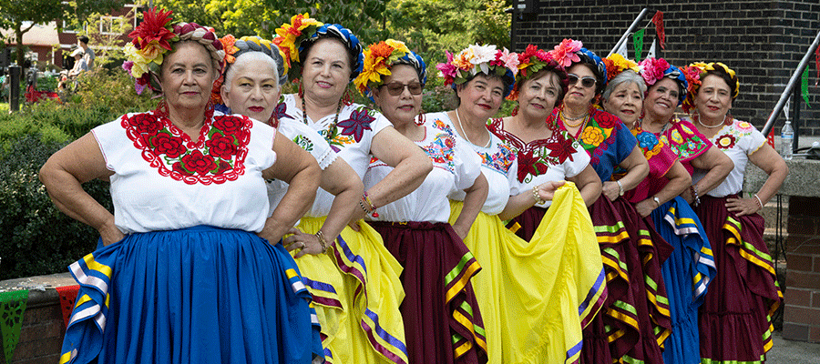 Line of female dancers in traditional dress at El Grito