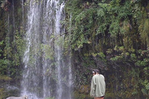 Kiyomi takes in a waterfall