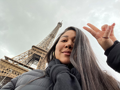 Kiyomi Arbuckle poses with the Eiffel Tower