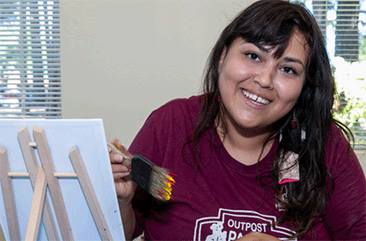 Woman with paint brush and canvas