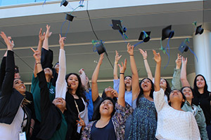 Interns throwing graduation caps