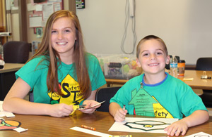 Student doing crafts with child